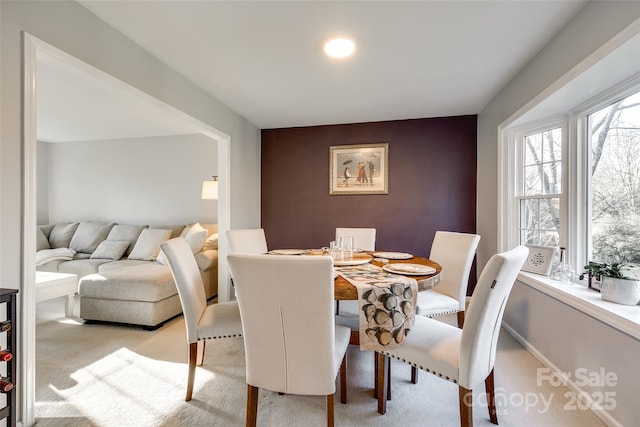 dining space with light colored carpet