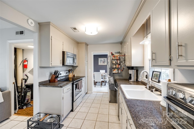 kitchen featuring sink, stainless steel appliances, and light tile patterned floors