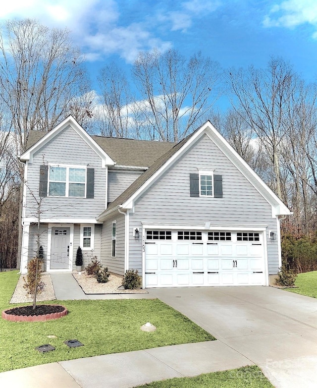 view of front of home featuring a garage and a front yard