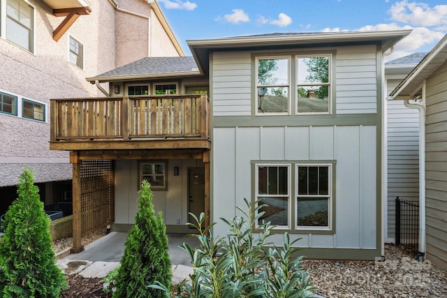 back of property with a balcony