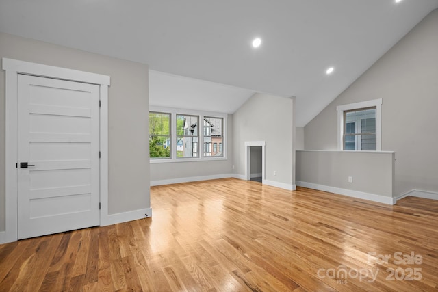 unfurnished living room featuring light hardwood / wood-style flooring and vaulted ceiling