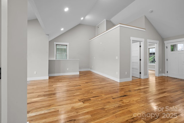 unfurnished living room with light hardwood / wood-style flooring and lofted ceiling