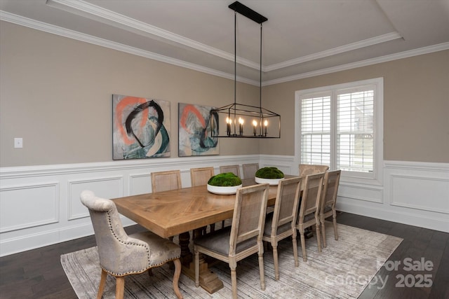 dining room with crown molding, a chandelier, and dark hardwood / wood-style flooring