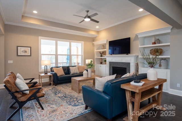 living room featuring ornamental molding, a fireplace, and dark hardwood / wood-style flooring