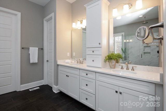 bathroom featuring vanity and an enclosed shower