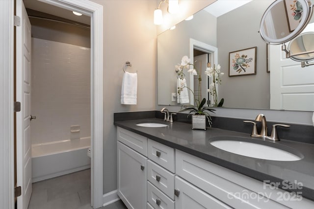 full bathroom with tile patterned floors, vanity, toilet, and  shower combination