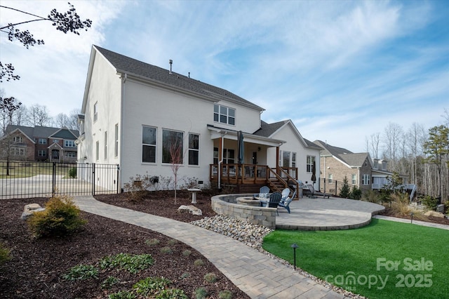 rear view of house featuring a yard and a patio