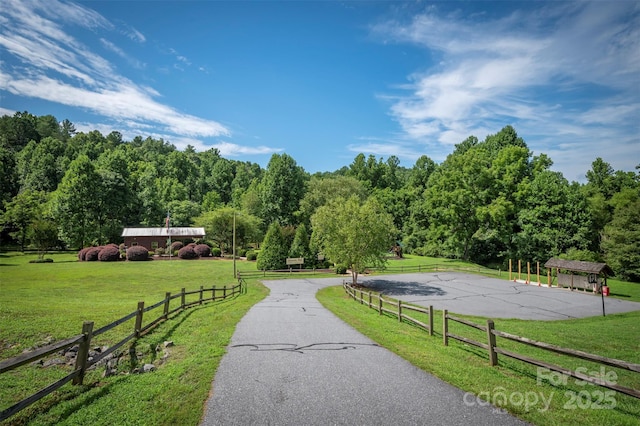 surrounding community featuring a yard and a rural view