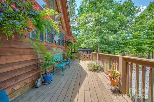 wooden terrace with a storage shed