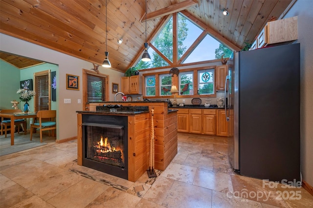 kitchen with a kitchen island, hanging light fixtures, high vaulted ceiling, stainless steel fridge, and wooden ceiling