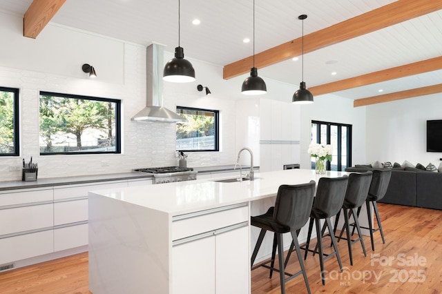 22 Innsbrook Rd, Asheville, NC 28804 - kitchen with an island with sink, sink, white cabinets, range, and wall chimney exhaust hood