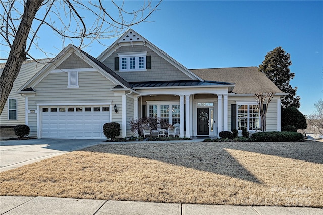 view of front of property with covered porch and a garage