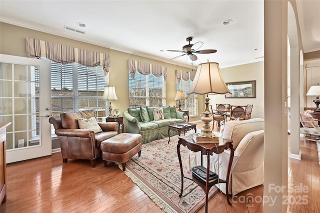 living room with ceiling fan, hardwood / wood-style floors, and crown molding