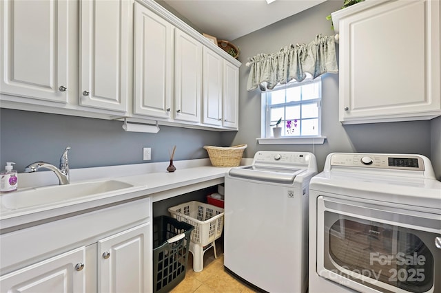 laundry room featuring cabinets, light tile patterned floors, separate washer and dryer, and sink