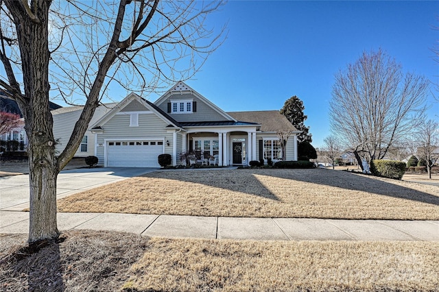 view of front of home with a garage and a front lawn