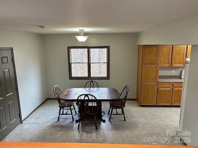 dining space featuring light tile patterned floors