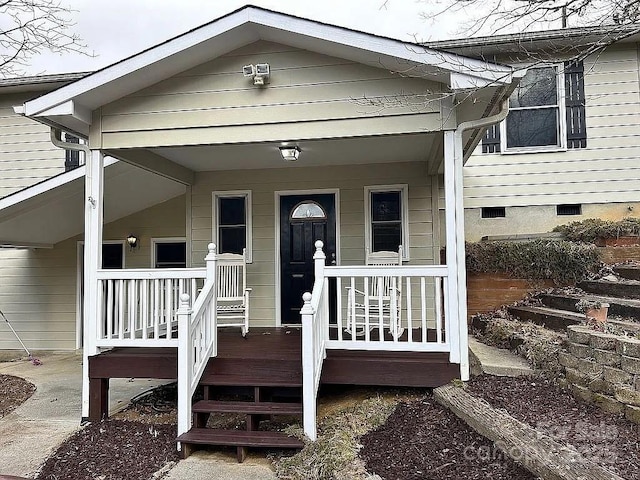 view of exterior entry with crawl space and covered porch