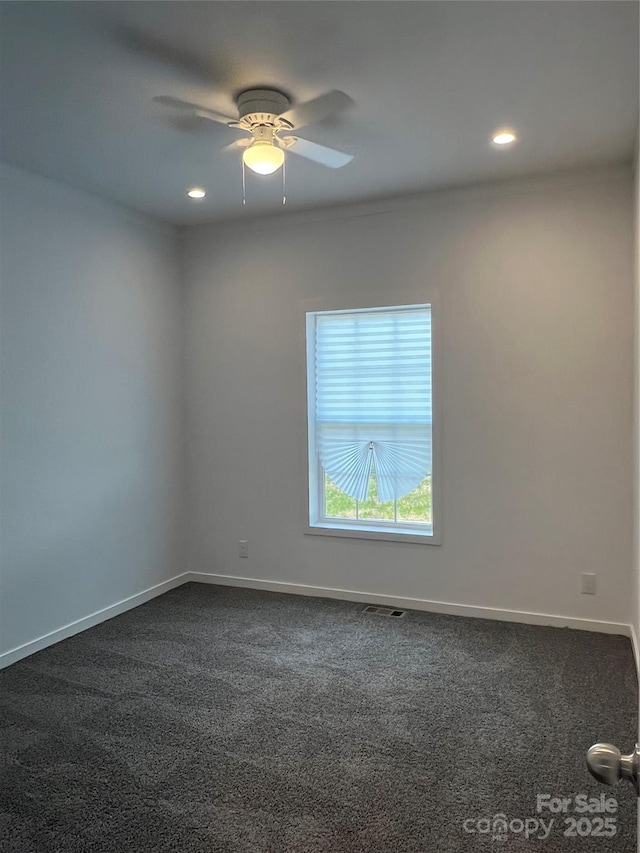819 Wellwood Ave, Statesville, NC 28677 - spare room featuring visible vents, dark colored carpet, and baseboards