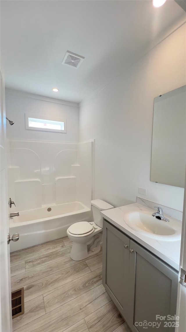 819 Wellwood Ave, Statesville, NC 28677 - bathroom featuring visible vents, shower / bathtub combination, toilet, wood finished floors, and vanity