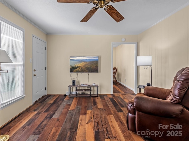 sitting room featuring ornamental molding, dark wood-type flooring, and ceiling fan