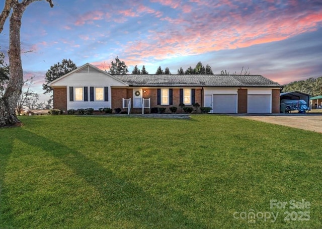 ranch-style house featuring a garage and a lawn