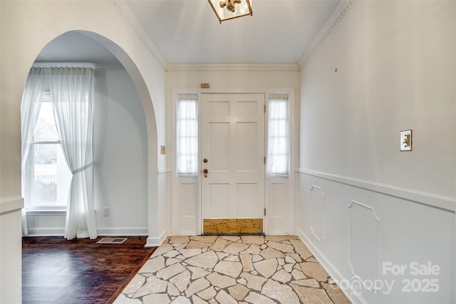 foyer entrance featuring hardwood / wood-style flooring and ornamental molding