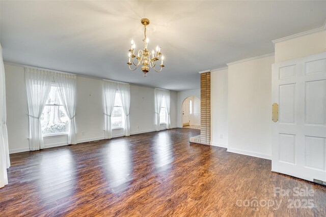 unfurnished living room featuring ornamental molding, dark wood-type flooring, and a chandelier