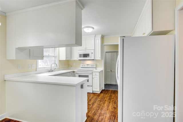 kitchen featuring sink, white cabinets, crown molding, dark wood-type flooring, and white appliances