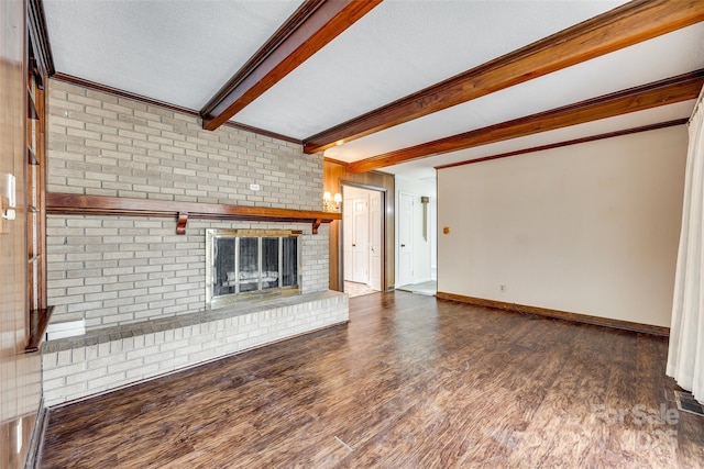 unfurnished living room with dark wood-type flooring, a textured ceiling, a fireplace, and beamed ceiling