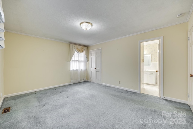 unfurnished room with crown molding, light colored carpet, and a textured ceiling