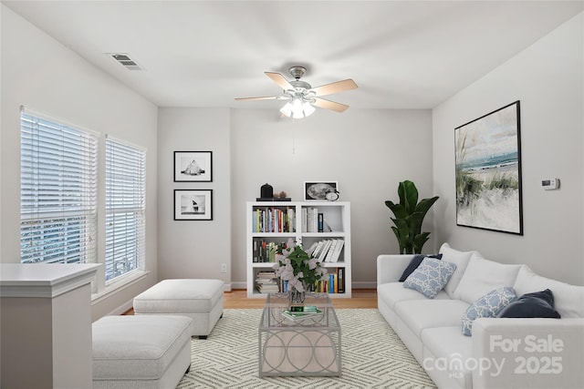 living room with ceiling fan and light wood-type flooring