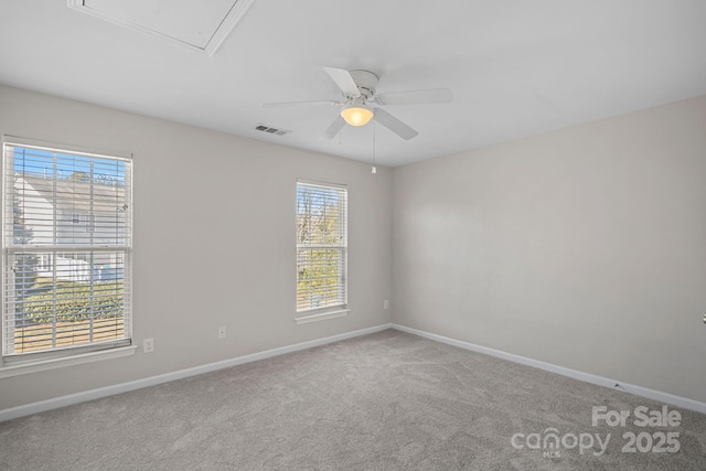 carpeted empty room with ceiling fan and a healthy amount of sunlight