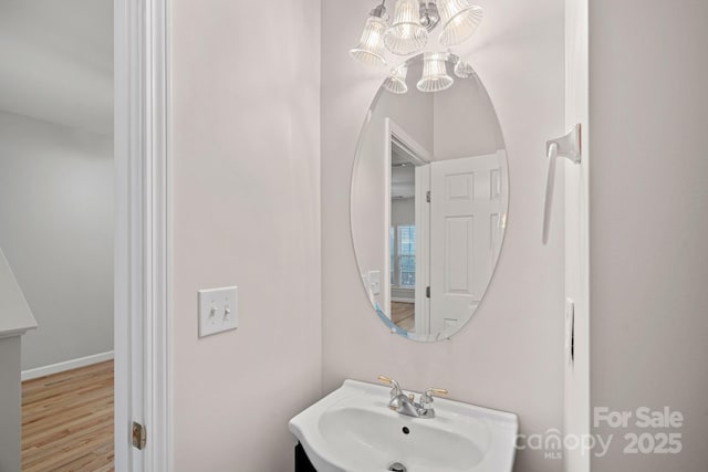 bathroom featuring sink and a notable chandelier