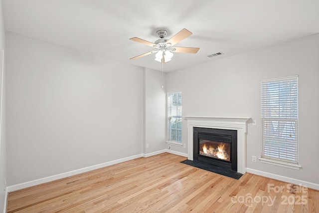 unfurnished living room with ceiling fan and light hardwood / wood-style flooring