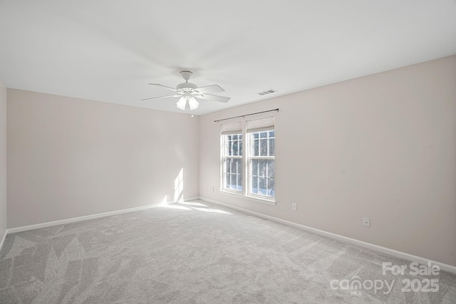 unfurnished room featuring ceiling fan and carpet