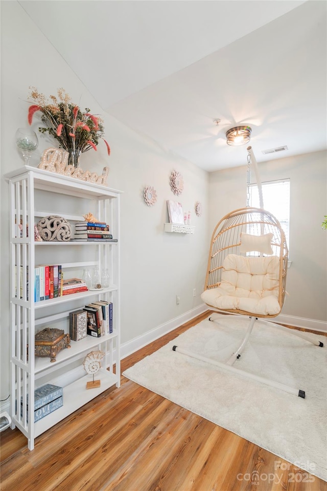 living area featuring hardwood / wood-style flooring and lofted ceiling