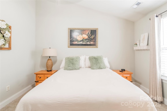 bedroom with multiple windows, carpet flooring, and vaulted ceiling