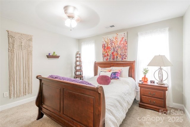 bedroom featuring light colored carpet and ceiling fan