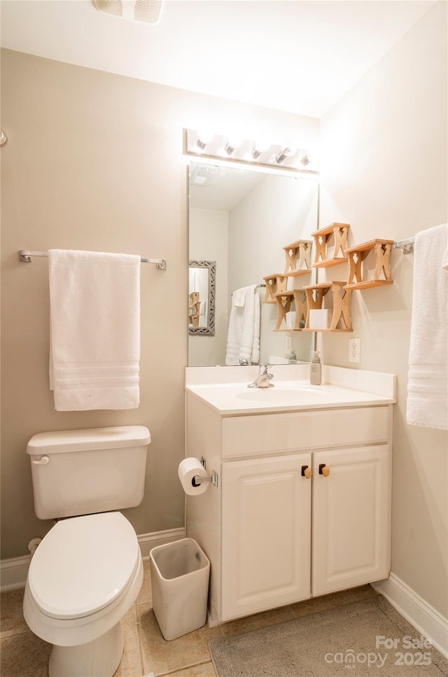 bathroom featuring toilet, tile patterned flooring, and vanity