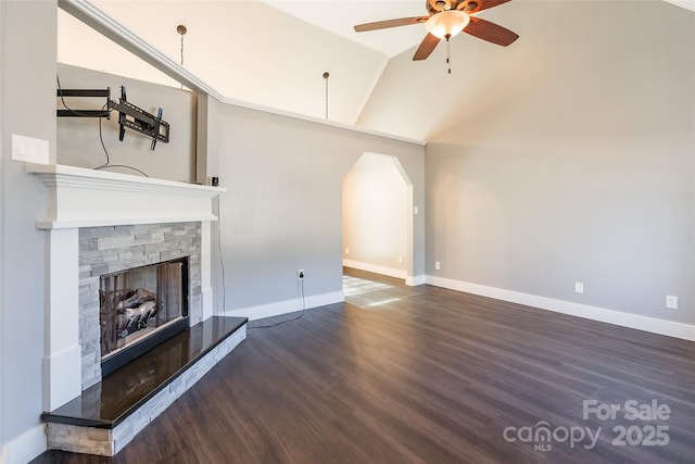 unfurnished living room featuring ceiling fan, lofted ceiling, dark hardwood / wood-style floors, and a stone fireplace