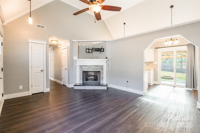 unfurnished living room featuring dark hardwood / wood-style flooring, a stone fireplace, ceiling fan, ornamental molding, and high vaulted ceiling