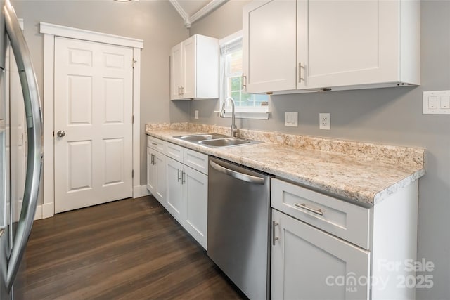 kitchen with sink, white cabinetry, appliances with stainless steel finishes, ornamental molding, and dark hardwood / wood-style flooring