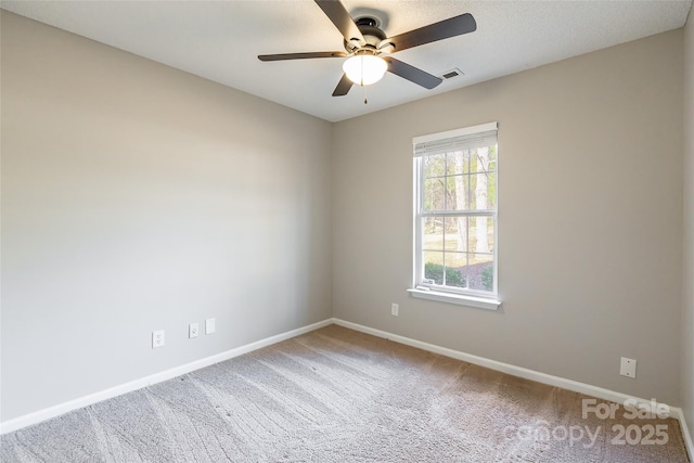 carpeted empty room featuring ceiling fan