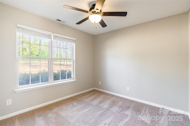 carpeted spare room with ceiling fan