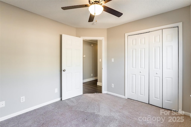 unfurnished bedroom with ceiling fan, a closet, and carpet flooring