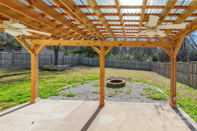 view of patio with ceiling fan and a fire pit