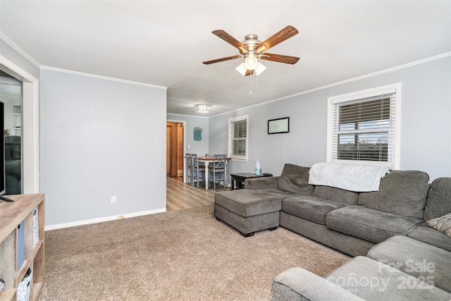 living room with ceiling fan, light colored carpet, and crown molding