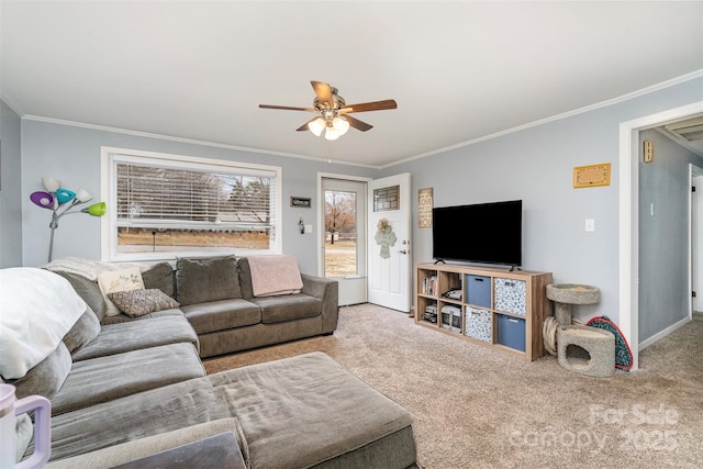 carpeted living room with ceiling fan and ornamental molding