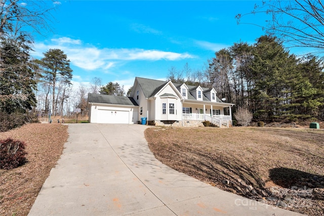 view of front of property featuring a garage, covered porch, and a front lawn