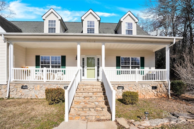 new england style home with a porch